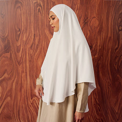Rawda in White TudungPeople instant hijab styled for modest wear, featuring a sleek white fabric and simple design.