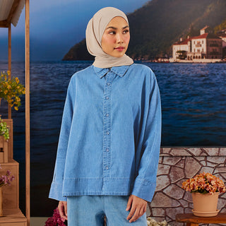 Medium blue denim loose top from TudungPeople, casual apparel with a relaxed fit and stylish design, displayed on a hanger.