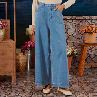 Medium blue denim wide pants from TudungPeople, featuring a relaxed fit and casual style, shown on a model.