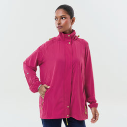 Magenta lightweight packable parka jacket by TudungPeople, shown folded and ready to wear, ideal for travel and outdoor activities.
