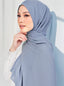 Muna chiffon signature TudungPeople hijab in soft pastel pink, draped elegantly with delicate fabric details.