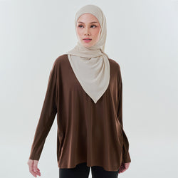 Brown oversized Dryfit top by TudungPeople, made of breathable athletic fabric, displayed on a hanger.