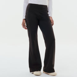 Black TudungPeople straight active pants displayed on a hanger, showcasing their slim fit and comfortable athletic design.