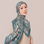 TudungPeople Atelier teal print, square scarf with intricate design, showcasing vibrant teal color and detailed pattern.