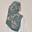 Teal-colored Atelier print from TudungPeople, square layout, featuring intricate design details in a vibrant teal shade.