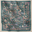 Square teal print scarf from TudungPeople's Atelier collection, featuring vibrant, detailed fabric design.
