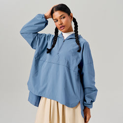 TudungPeople Flare Parka in Lagoon, a stylish women’s apparel with a flared design, featuring a cozy hood and front pockets.