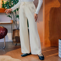Off-white knitted pants by TudungPeople, showcasing a cozy, stylish apparel design with a comfortable fit and textured fabric.