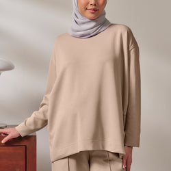 TudungPeople oversized latte-colored sweatshirt, casual apparel with a relaxed fit, displayed on a hanger.