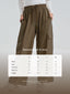 Black TudungPeople Siza athleisure track pants displayed on a hanger with a focus on the fit and fabric texture.